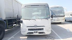 2020 Toyota Coaster — Full Front View — Photo 1 — Thumbnail