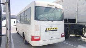 2020 Toyota Coaster — Rear Left Angle — Photo 6 — Thumbnail